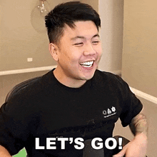a man is laughing and saying let 's go