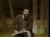 a man with a beard is holding a piece of paper and says " you can say to yourself "