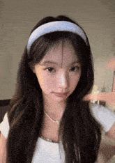 a woman wearing a headband that says ' abercrombie & fitch ' on it