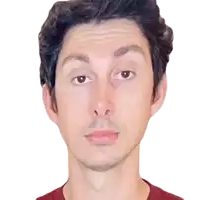 a close up of a man 's face with a red shirt
