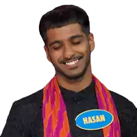 a man wearing a scarf and a name tag that says hasan