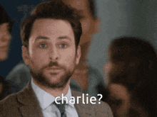 a man in a suit and tie asks charlie