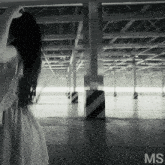 a woman in a white dress is standing in an empty parking garage with the letters ms above her