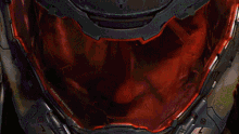 a close up of a video game character 's helmet with a green light on it .