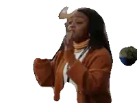 a woman in an orange sweater is holding her hands up