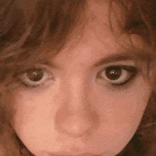 a close up of a woman 's face with a very serious look on her face
