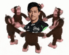 a man wearing a stake by team shirt is surrounded by monkeys