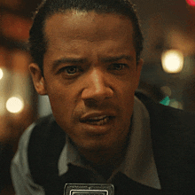 a close up of a man 's face with a sticker that says ' i ' on it