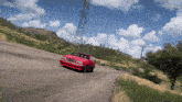 a red car is driving down a dirt road with a license plate that says jcj