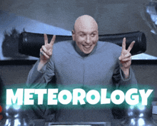 a bald man giving a peace sign with the word meteorology behind him