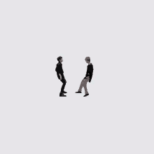 a couple of men are standing next to each other on a white background .