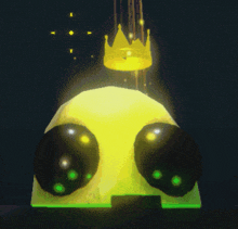 a yellow object with black eyes and a gold crown on top