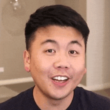 a close up of a man 's face with his mouth open and his teeth visible .