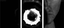a black and white photo of a man holding a gun in his hand .