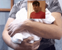 a man in a red polo shirt is holding a white cloth