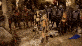 a group of soldiers are standing around a woman holding a bow