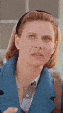 a close up of a woman 's face with a headband on her head