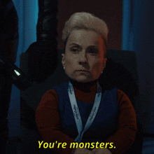 a woman with a lanyard that says you 're monsters on it