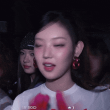 a woman wearing a white t-shirt that says supreme on the front