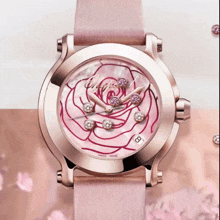 a chopard watch with a pink band and a pink rose on the face