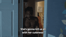 a shirtless man is standing in a doorway with the words she 's gonna kill us all with her cuteness