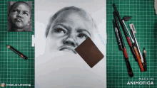 a drawing of a child is on a green cutting mat