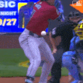 a baseball player in a red shirt with the number 7 on the back