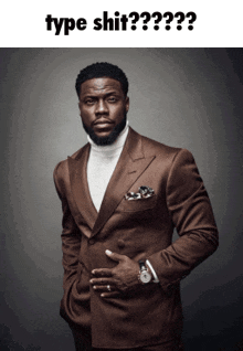 a man in a brown suit and white turtleneck is standing with his hands in his pockets