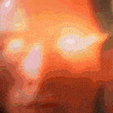 a close up of a red and orange background with a few white spots