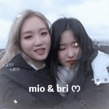 two girls posing for a picture with the words mio & bri