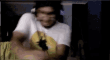 a man in a white shirt is standing in a dark room .