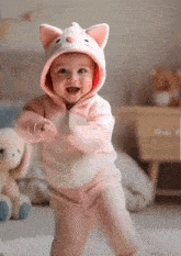 a baby dressed in a cat costume is dancing
