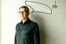 a man with glasses stands in front of a white board with a speech bubble that says when platon is being himself