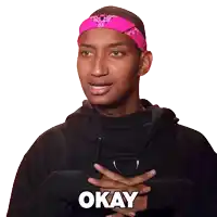 a man wearing a pink headband and a black hoodie says okay