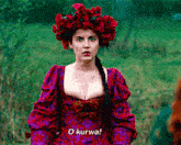 a woman in a red and purple dress with a red flower crown on her head says o kurwa