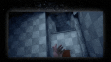 a person 's hand is reaching out towards a checkered floor