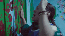a netflix ad shows a woman touching a wall with her hand