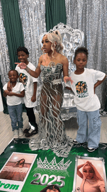 a woman in a prom dress is surrounded by children wearing shirts that say prom 2025