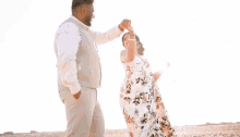 a man and woman are standing next to each other and the woman is smiling