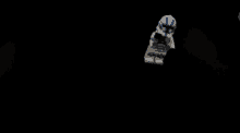 a white lego figure with a blue u on his head