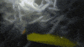 a blurry picture of a yellow object and a black background
