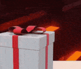 a white gift box with a red ribbon and a bow