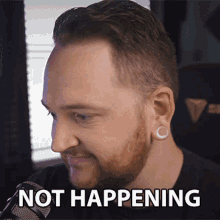 a man with a beard and ear plugs has the words not happening written on his face