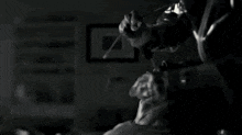 a close up of a person 's face in a dark room with a lot of smoke coming out of it .