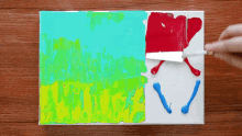 a person is painting a picture with a spatula