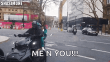 a man riding a motorcycle on a street with the words me n you