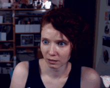 a woman with red hair has a nose ring on her nose