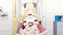 a girl with horns is standing in a hallway and smiling