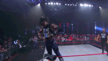 a wrestler wearing a shirt that says bullet club walks out of the ring