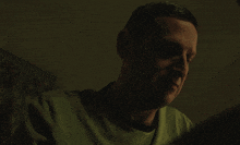 a man sits at a table with his hand over his face